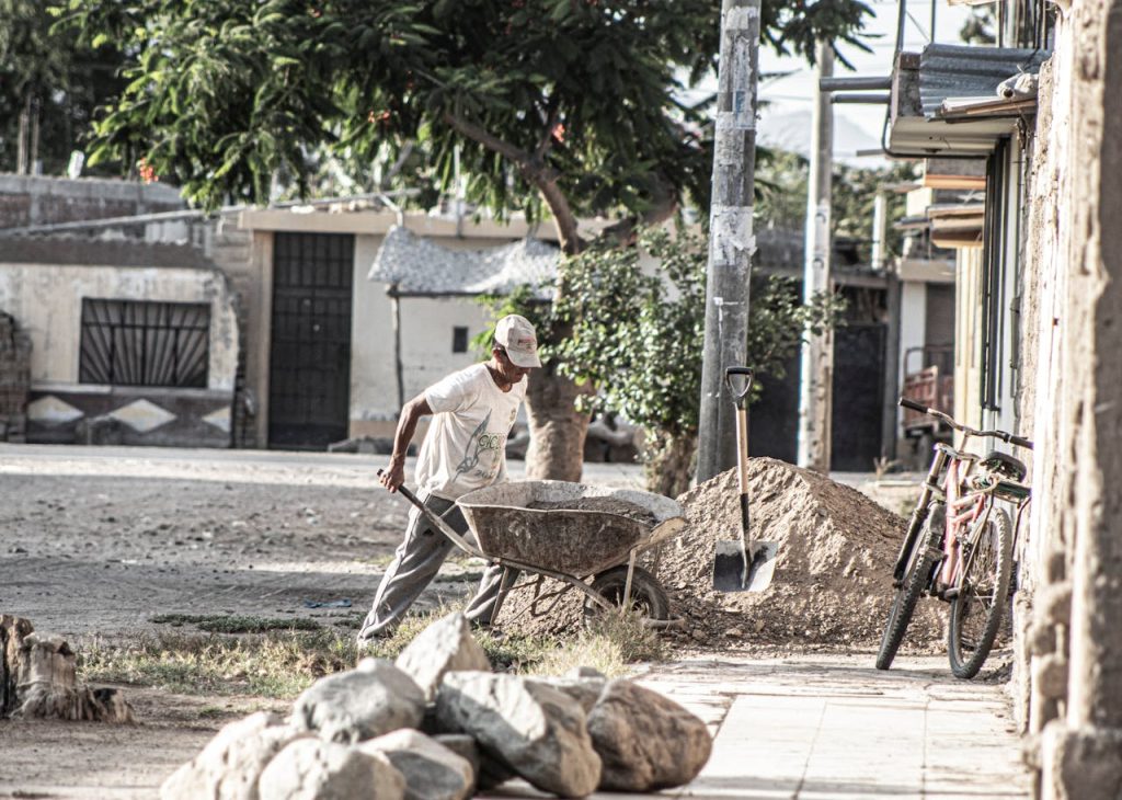 A laborer pushing a cart