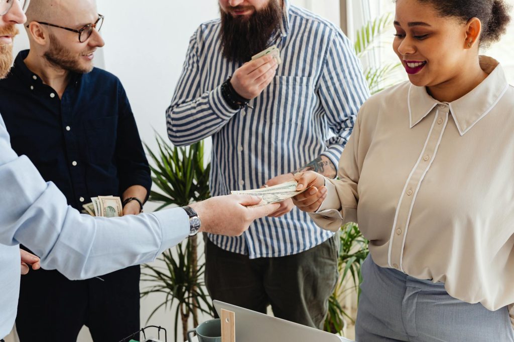 A manager handling out money to his employees